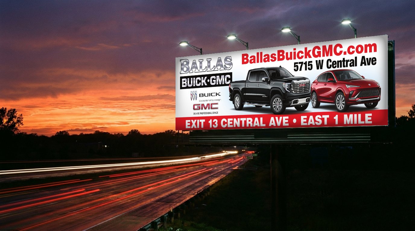 Ballas Buick GMC billboard lit at dusk over a highway