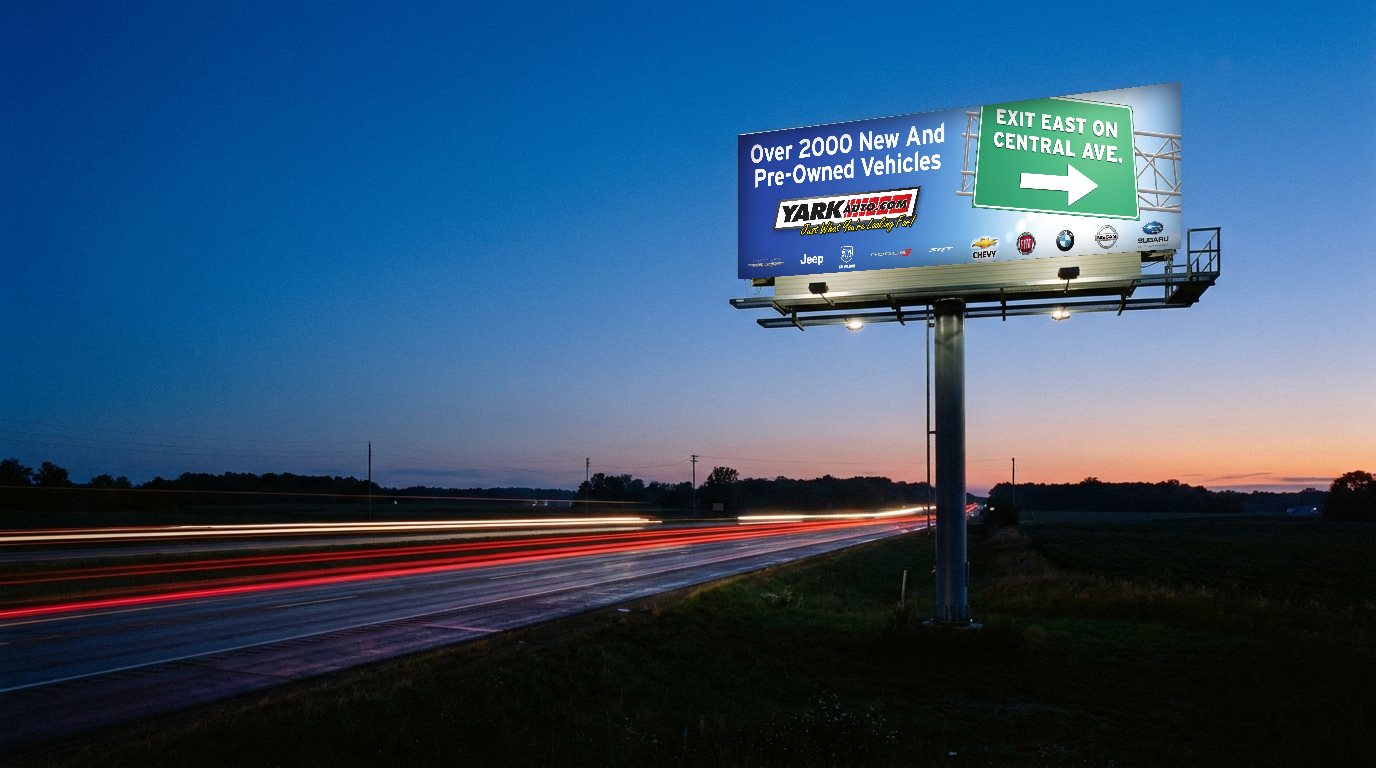 Yark Auto billboard beside a highway at dusk